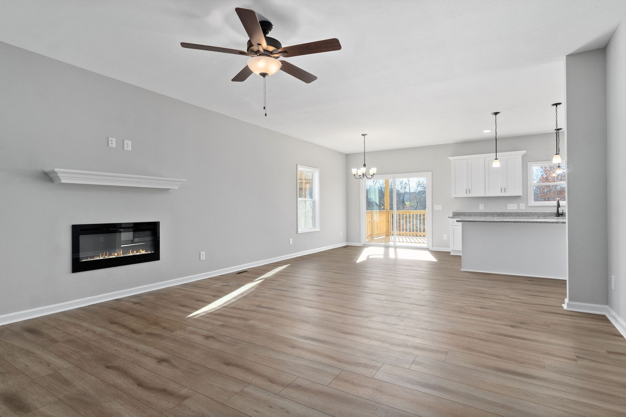 1042 Winesap Road Clarksville, TN 37040 - Photo 7 of 33 a view of an empty room with a kitchen and a fireplace