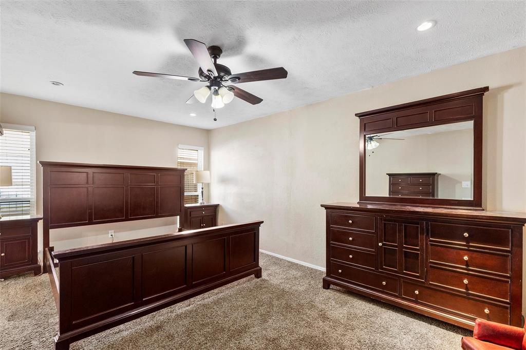 9212 Shipman Street Rowlett, TX 75088 - Photo 17 of 34 Primary bedroom featuring light carpet, a ceiling fan and recessed lighting