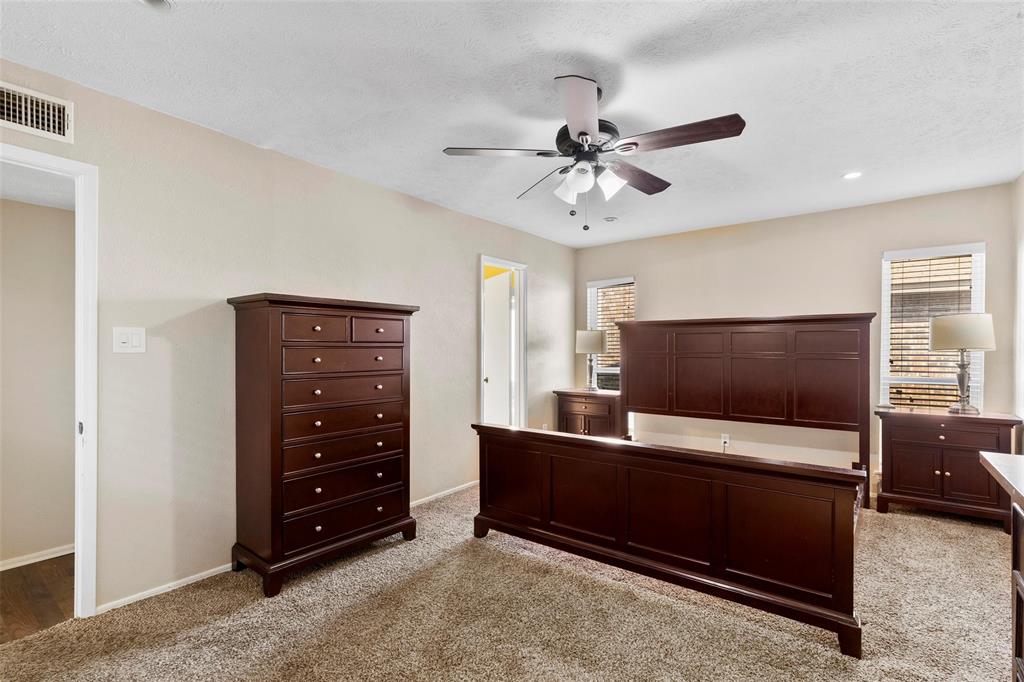 9212 Shipman Street Rowlett, TX 75088 - Photo 18 of 34 Carpeted primary bedroom with a ceiling fan and recessed lighting