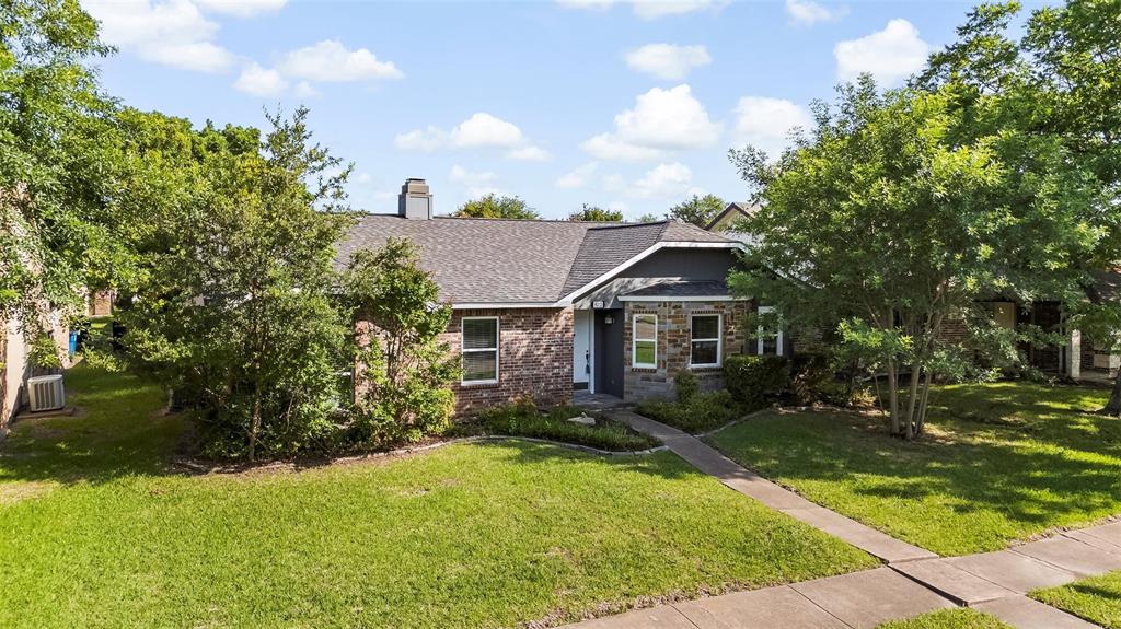 9212 Shipman Street Rowlett, TX 75088 - Photo 2 of 34 View of front of property with a front lawn, a chimney, Brick and stone