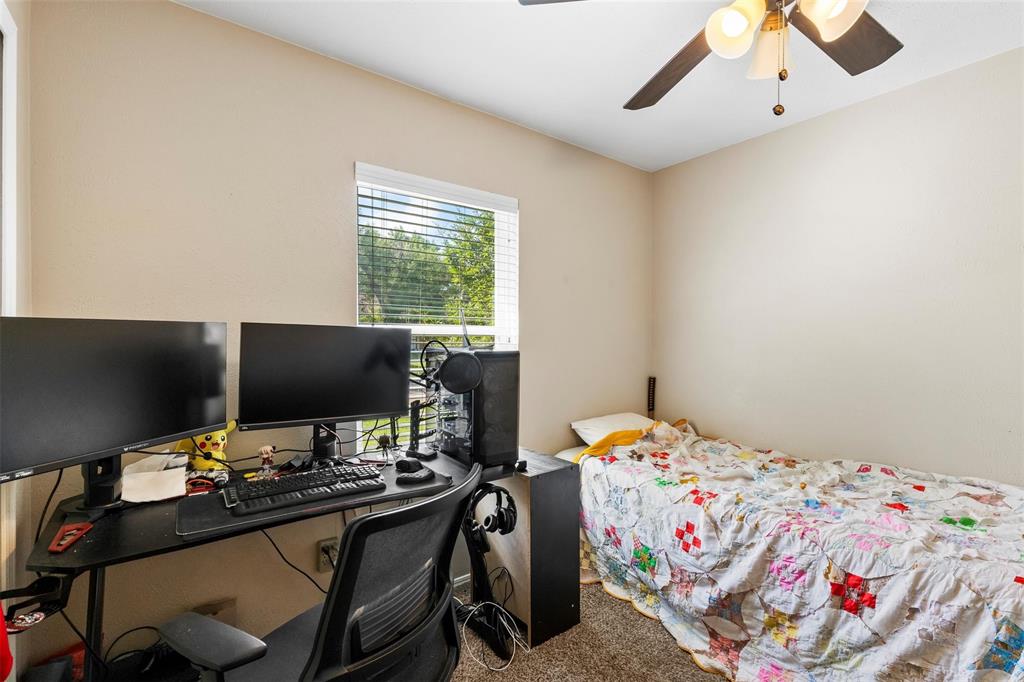 9212 Shipman Street Rowlett, TX 75088 - Photo 25 of 34 Bedroom featuring an office area, carpet, and a ceiling fan