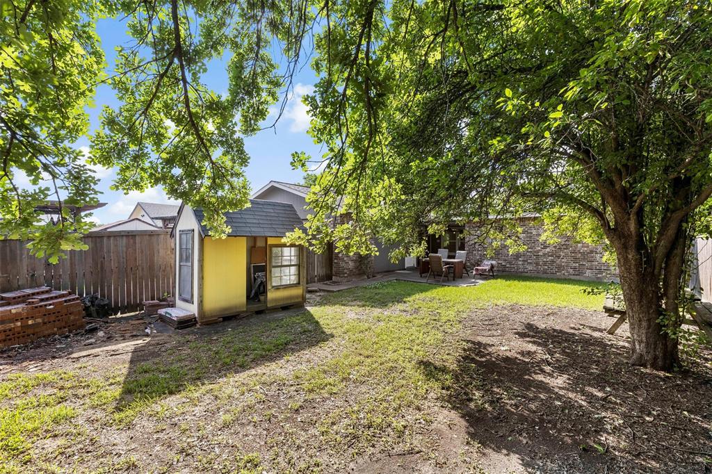 9212 Shipman Street Rowlett, TX 75088 - Photo 28 of 34 Fenced backyard with an outbuilding and a patio