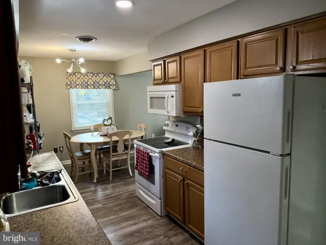 a kitchen with stainless steel appliances granite countertop a refrigerator stove and sink