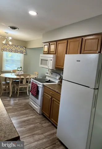 a kitchen with a refrigerator a stove top oven a sink and dishwasher