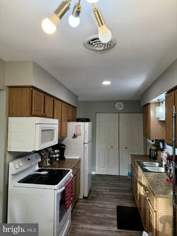 a kitchen with stainless steel appliances a sink stove and refrigerator