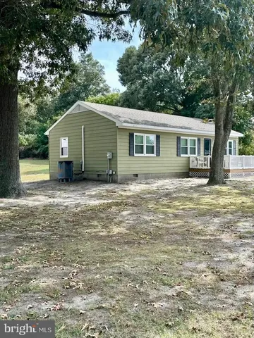 a house that has a tree in front of it