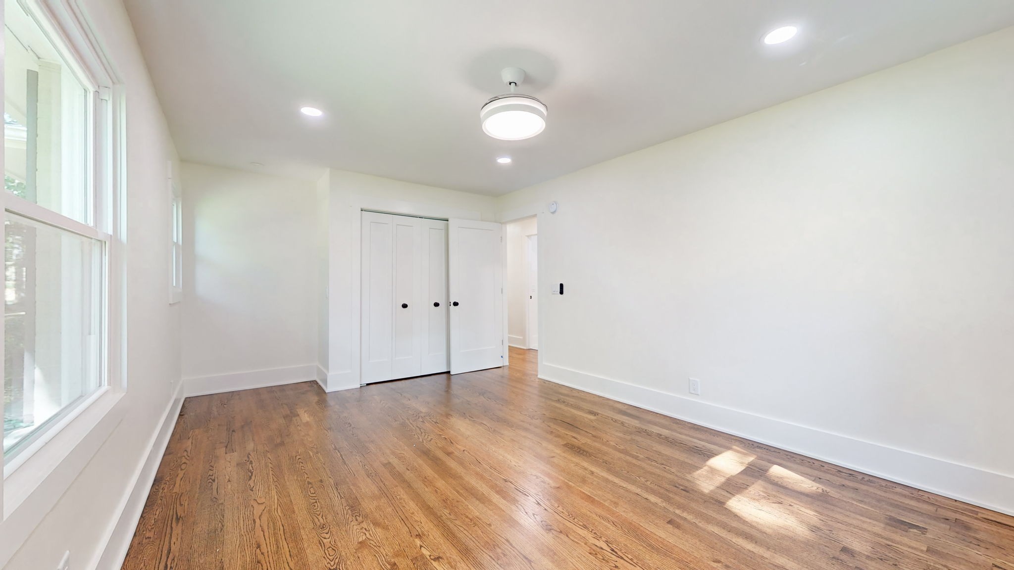 196 Thomas Street Manchester, TN 37355 - Photo 31 of 43 a view of an empty room with wooden floor and a window