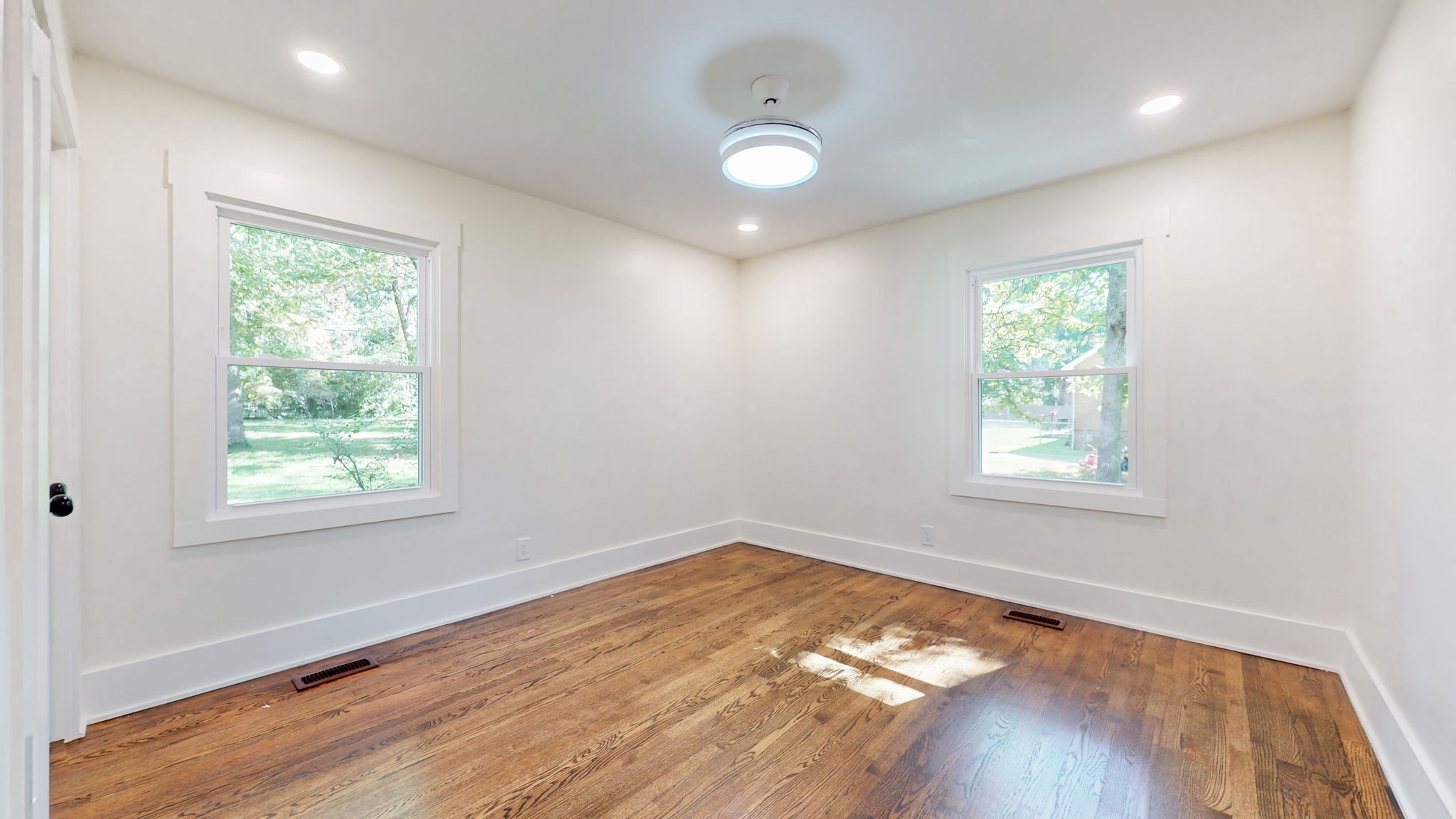 196 Thomas Street Manchester, TN 37355 - Photo 32 of 43 an empty room with wooden floor and windows