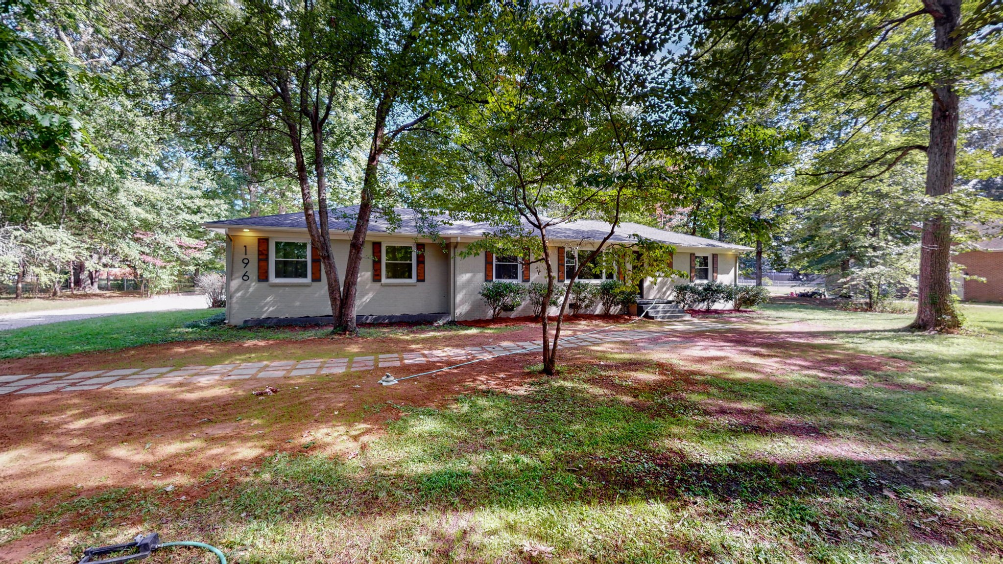 196 Thomas Street Manchester, TN 37355 - Photo 4 of 43 a view of a patio with a table and chairs under an umbrella