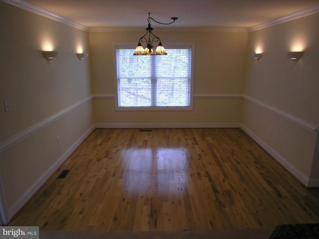 849 Valley View Road Harpers Ferry, WV 25425 - Photo 12 of 29 an empty room with wooden floor chandelier and windows