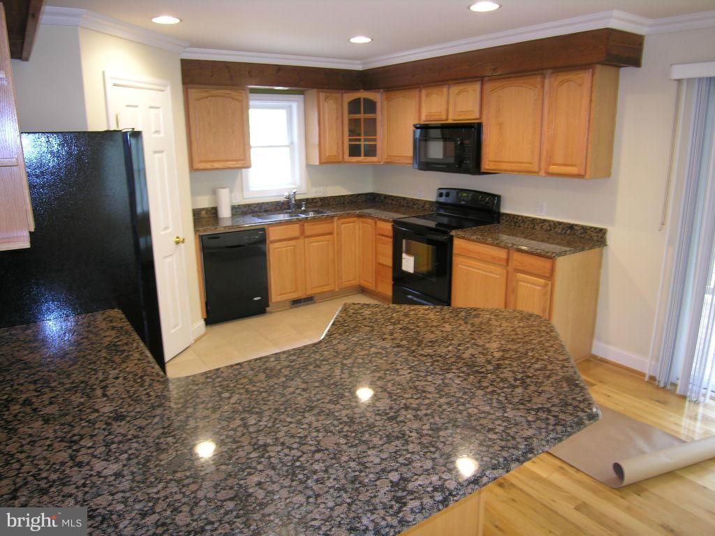 849 Valley View Road Harpers Ferry, WV 25425 - Photo 9 of 29 a kitchen with granite countertop a refrigerator and a stove top oven