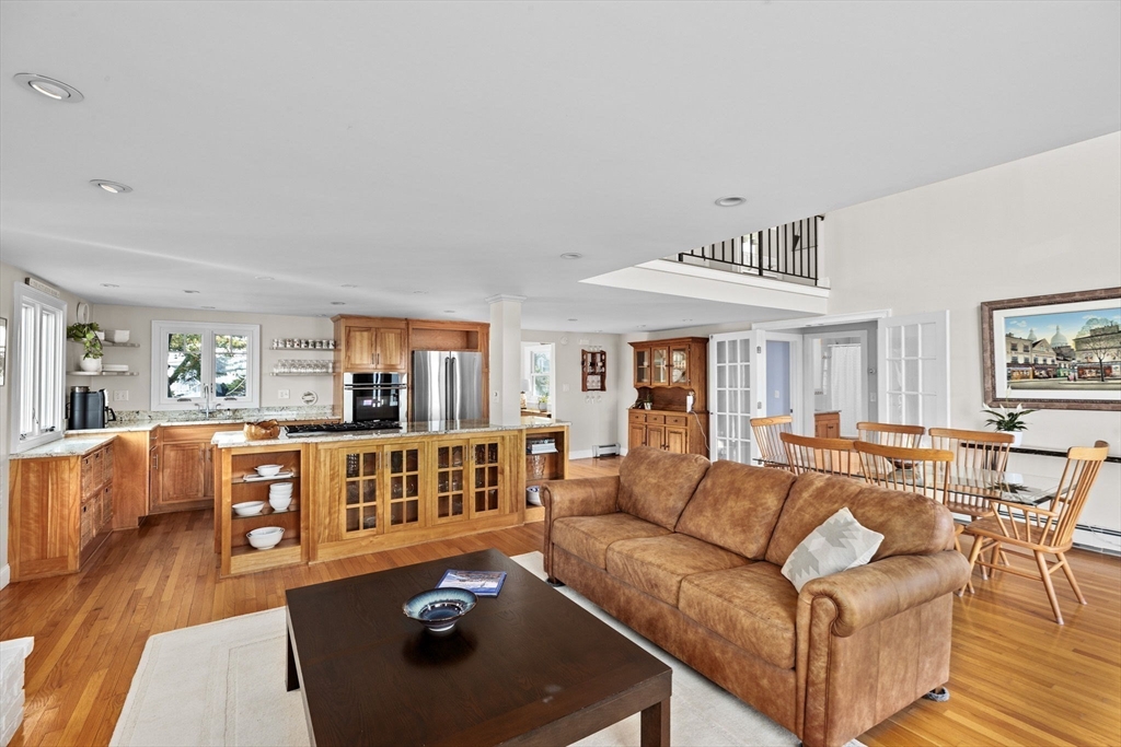45 Rebecca Road Scituate, MA 02066 - Photo 14 of 36 a living room with furniture and a dining table with wooden floor