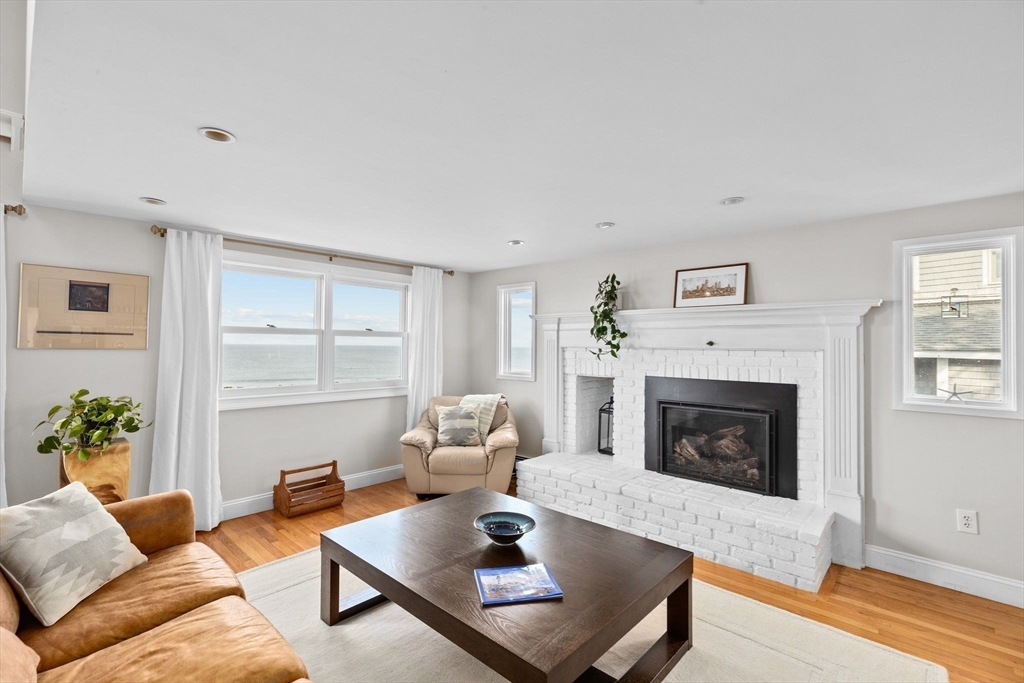 45 Rebecca Road Scituate, MA 02066 - Photo 17 of 36 a living room with furniture a rug and a fireplace