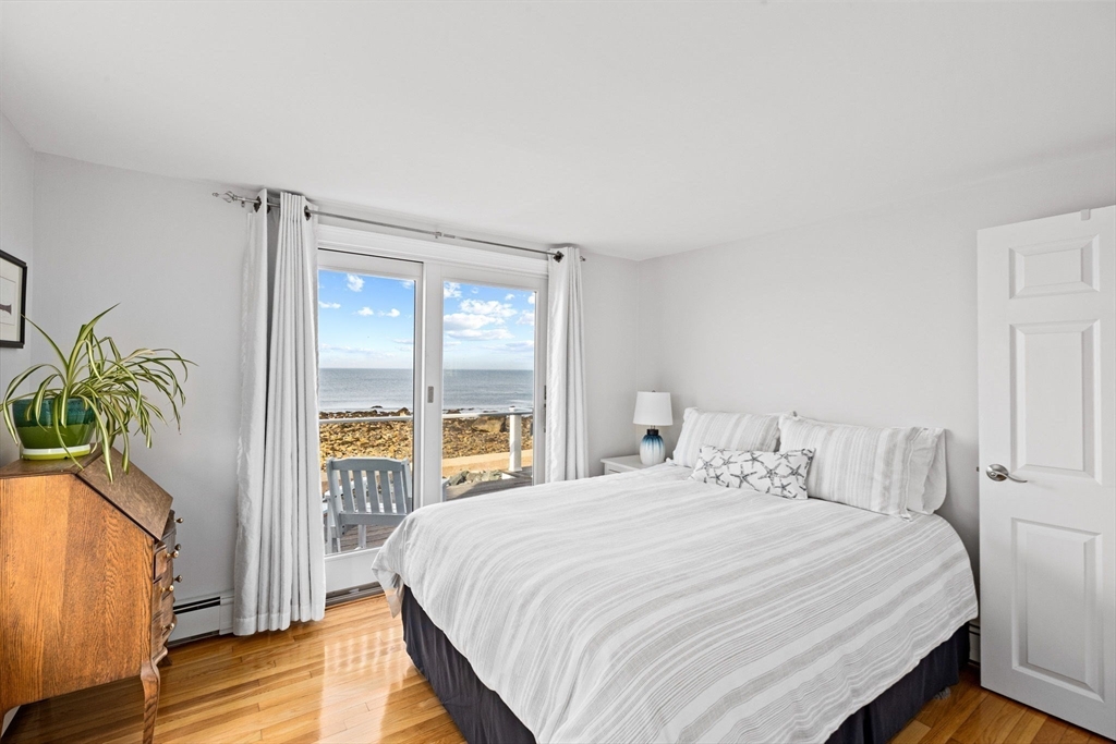 45 Rebecca Road Scituate, MA 02066 - Photo 27 of 36 a bedroom with a balcony a bed and a window