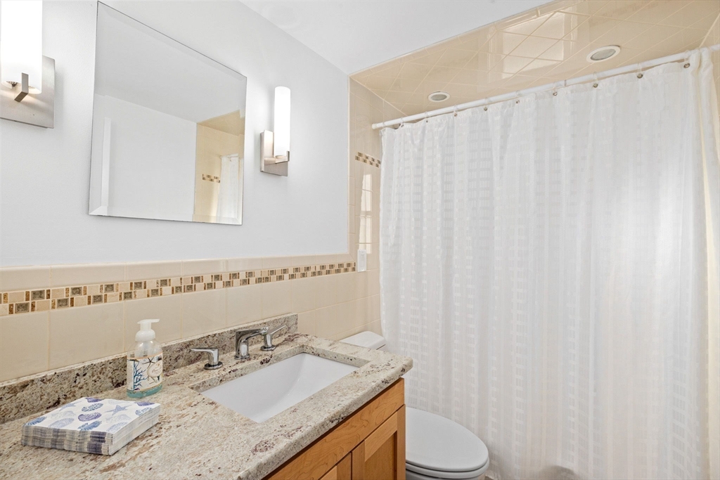 45 Rebecca Road Scituate, MA 02066 - Photo 29 of 36 a bathroom with a granite countertop sink and a mirror