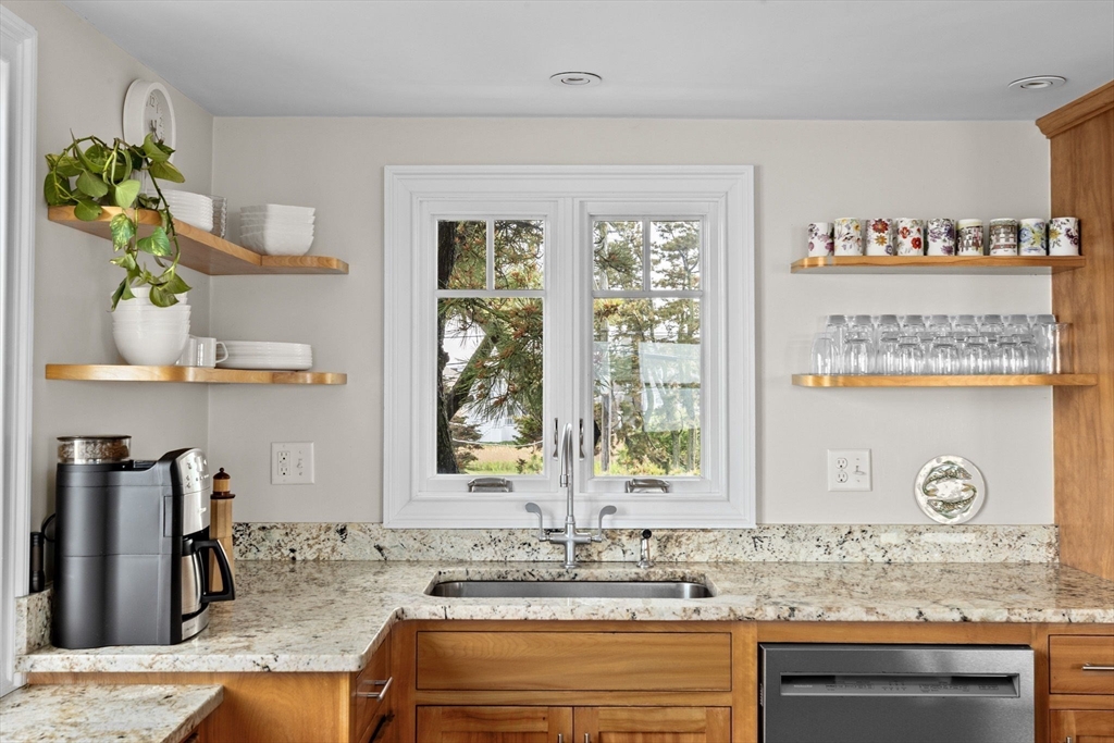 45 Rebecca Road Scituate, MA 02066 - Photo 8 of 36 a kitchen with granite countertop a sink a stove and a wooden floor