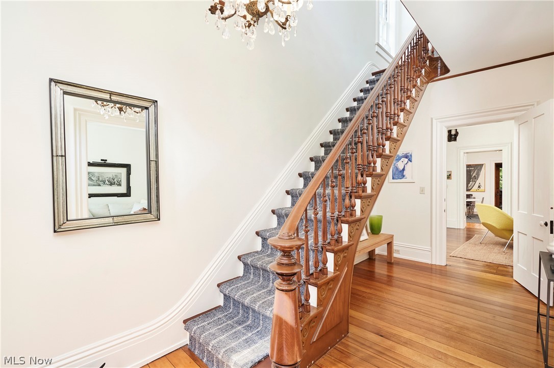5046 Alger Road Richfield, OH 44286 - Photo 30 of 49 Grand wooden staircase featuring intricate balusters and a carpet runner