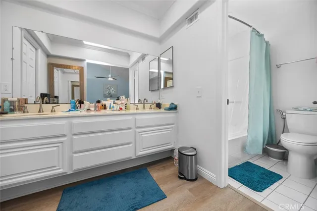 a spacious bathroom with a double vanity sink and a mirror