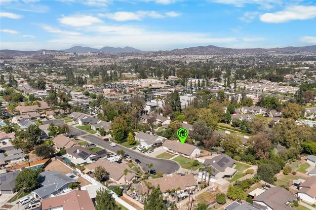 an aerial view of residential houses with city view