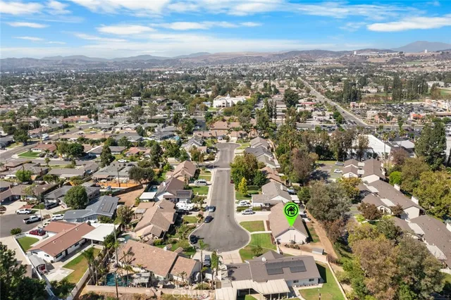 an aerial view of residential houses with city view