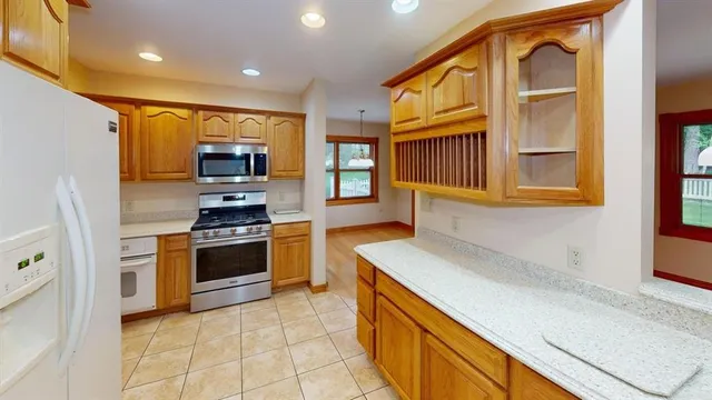 a kitchen with stainless steel appliances a stove a sink and a refrigerator