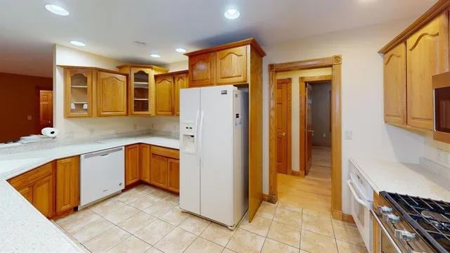 a kitchen with stainless steel appliances granite countertop a refrigerator and a sink