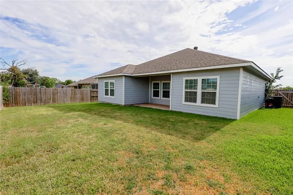a view of a house with a yard and sitting area