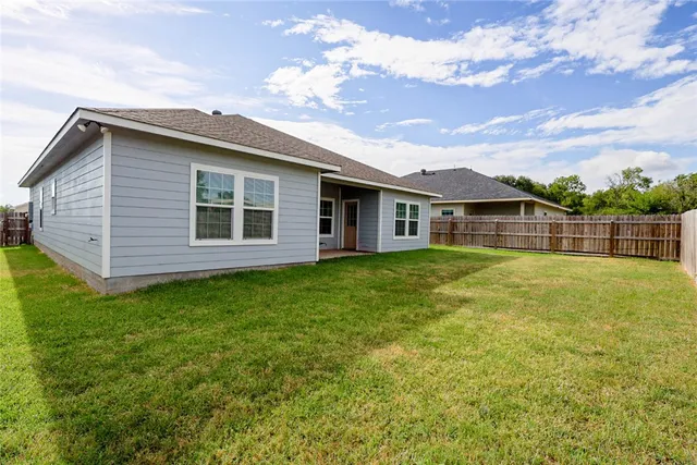 a view of a house with a backyard