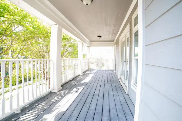 a view of balcony with wooden floor