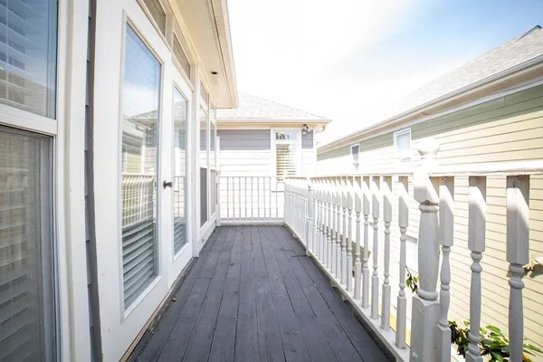 a view of a balcony with wooden floor