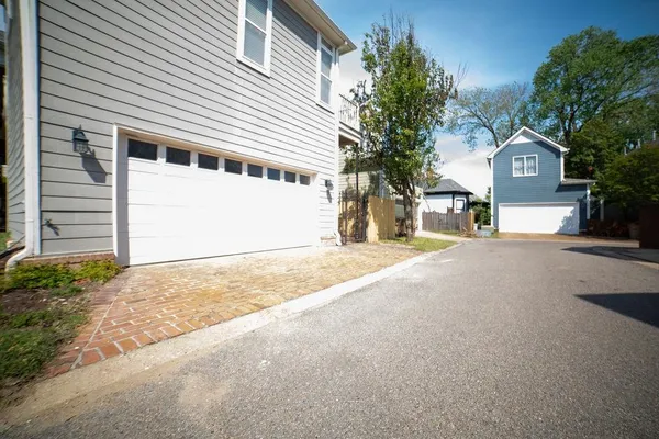 a view of a house with a yard and garage