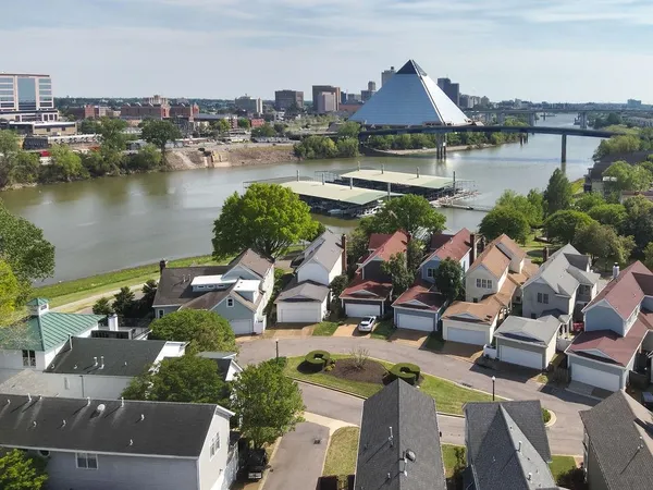 an aerial view of house with yard and lake view