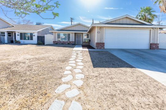 609 South Gemstone Street Ridgecrest, CA 93555 - Photo 4 of 35 a front view of a house with a yard and garage