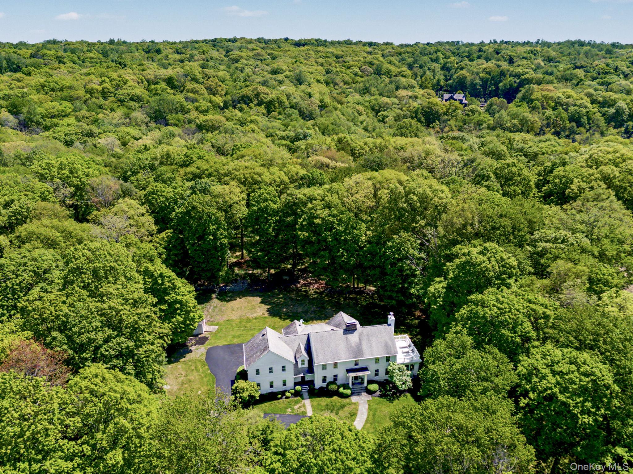 240 Eastwoods Road Pound Ridge, NY 10576 - Photo 2 of 13 an aerial view of a house with a yard