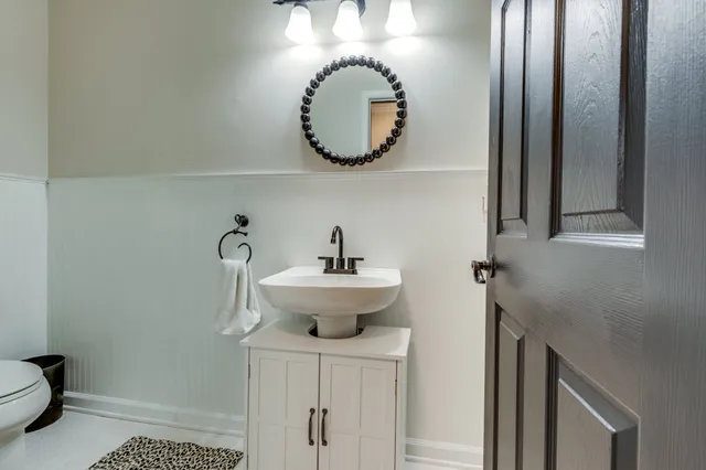 a kitchen with a refrigerator a stove a sink and dishwasher with wooden floor