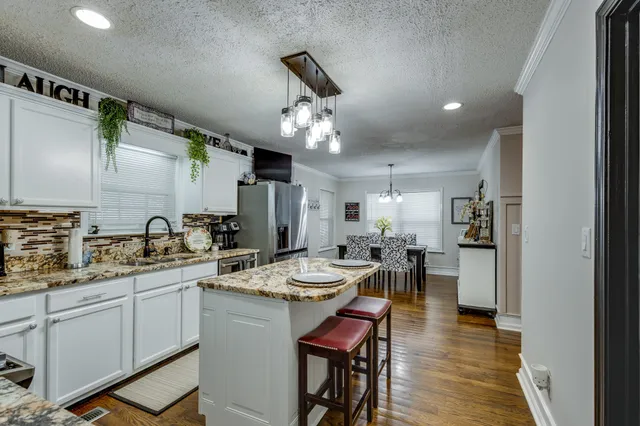 a view of a dining room with furniture and chandelier