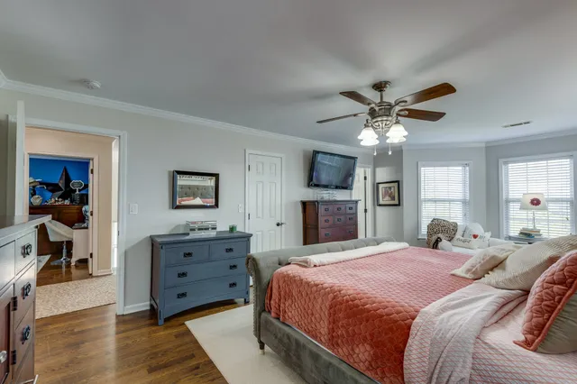 a bedroom with a bed and a chandelier