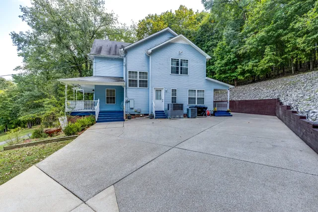 a front view of house with yard and green space