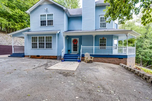 a view of backyard with barbeque oven and green space