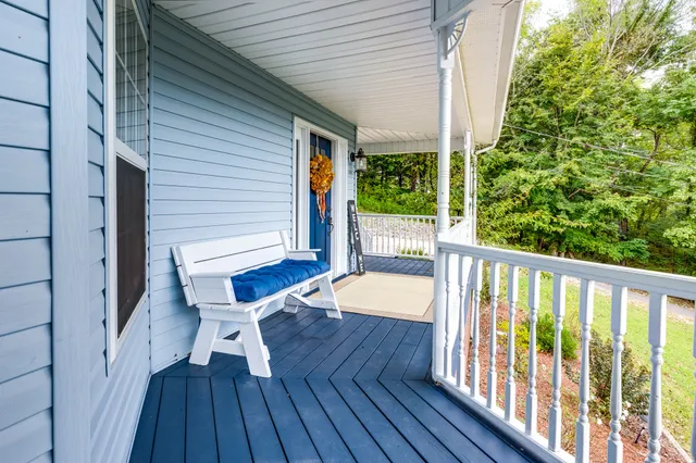 a view of a house with a yard and sitting area
