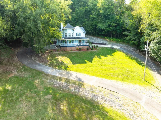 a front view of a house with a yard table and chairs