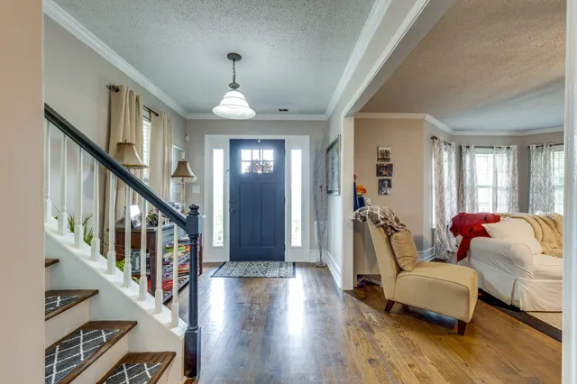 a living room with furniture fireplace and a large window