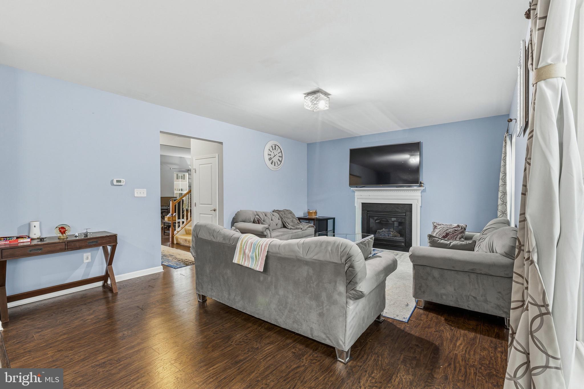 28 Snow Branch Road Clayton, DE 19938 - Photo 14 of 69 a living room with furniture fireplace and a flat screen tv
