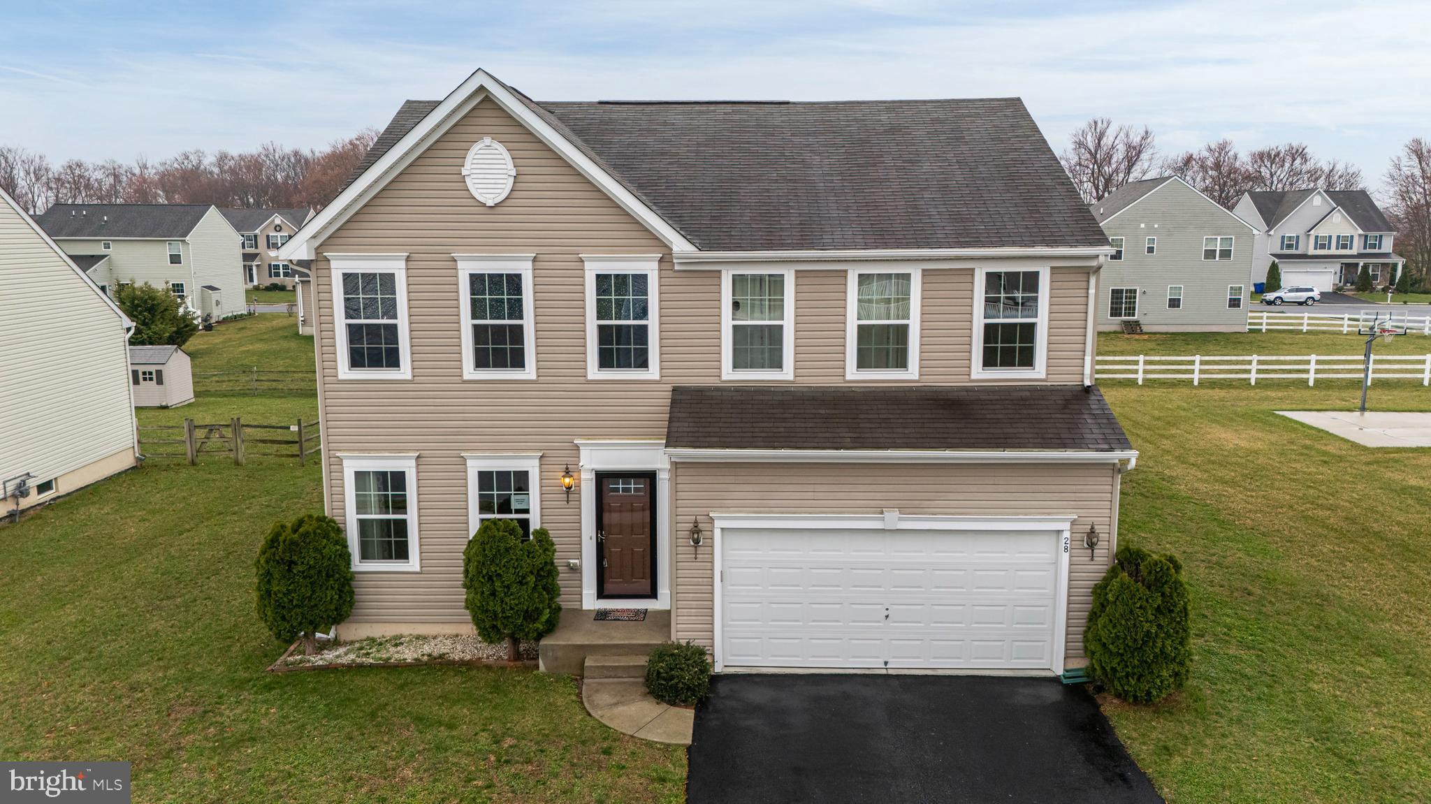 28 Snow Branch Road Clayton, DE 19938 - Photo 37 of 69 a front view of a house with a yard and garage