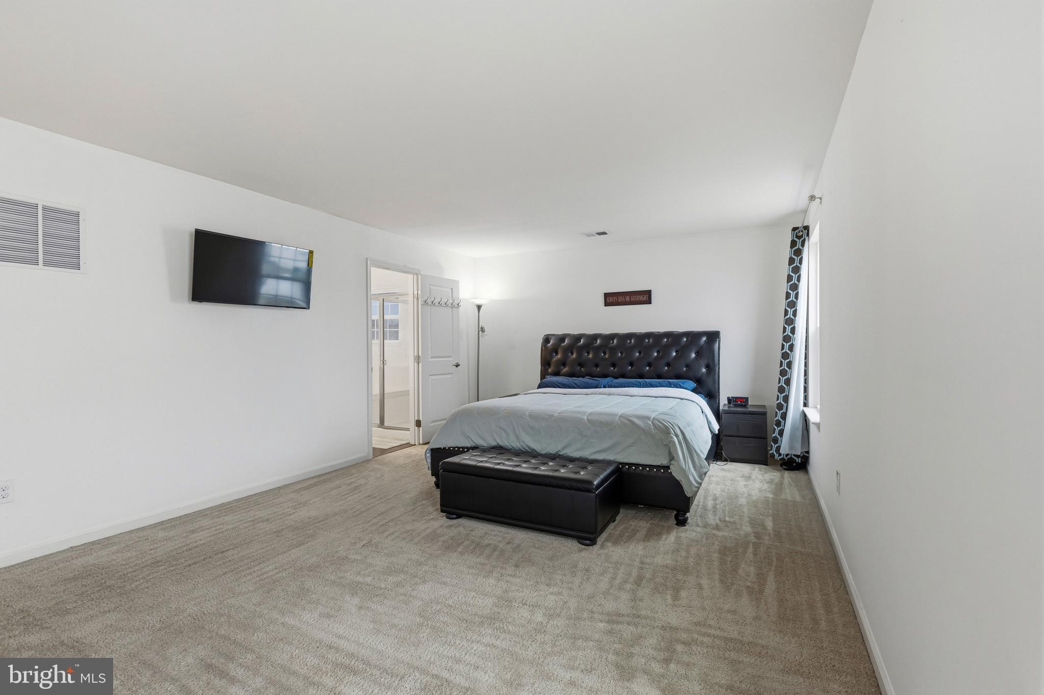 28 Snow Branch Road Clayton, DE 19938 - Photo 54 of 69 a spacious bedroom with a bed and a flat screen tv