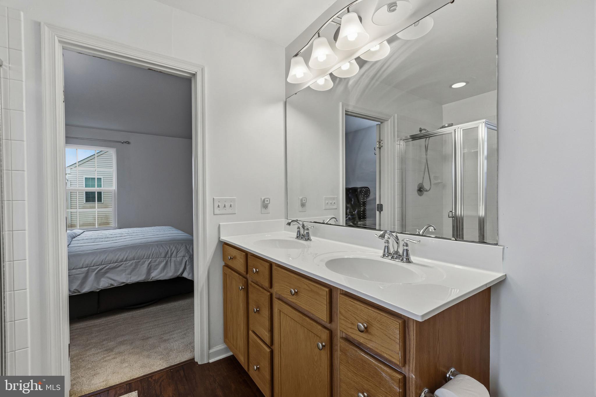28 Snow Branch Road Clayton, DE 19938 - Photo 58 of 69 a en suite bathroom with a double vanity sink and a mirror