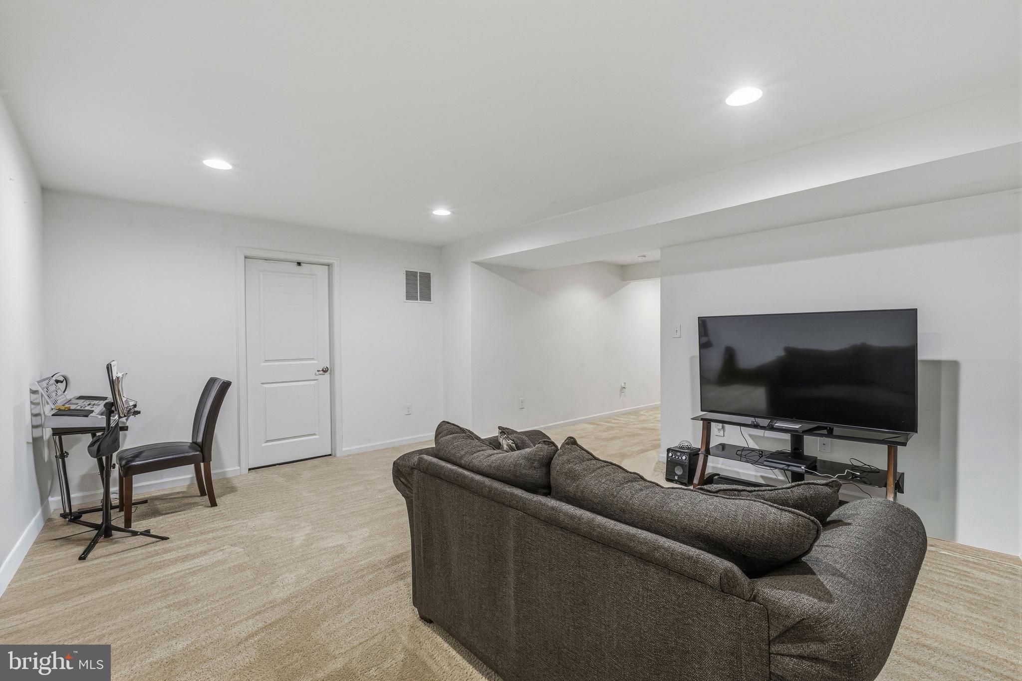 28 Snow Branch Road Clayton, DE 19938 - Photo 64 of 69 a living room with furniture and a flat screen tv