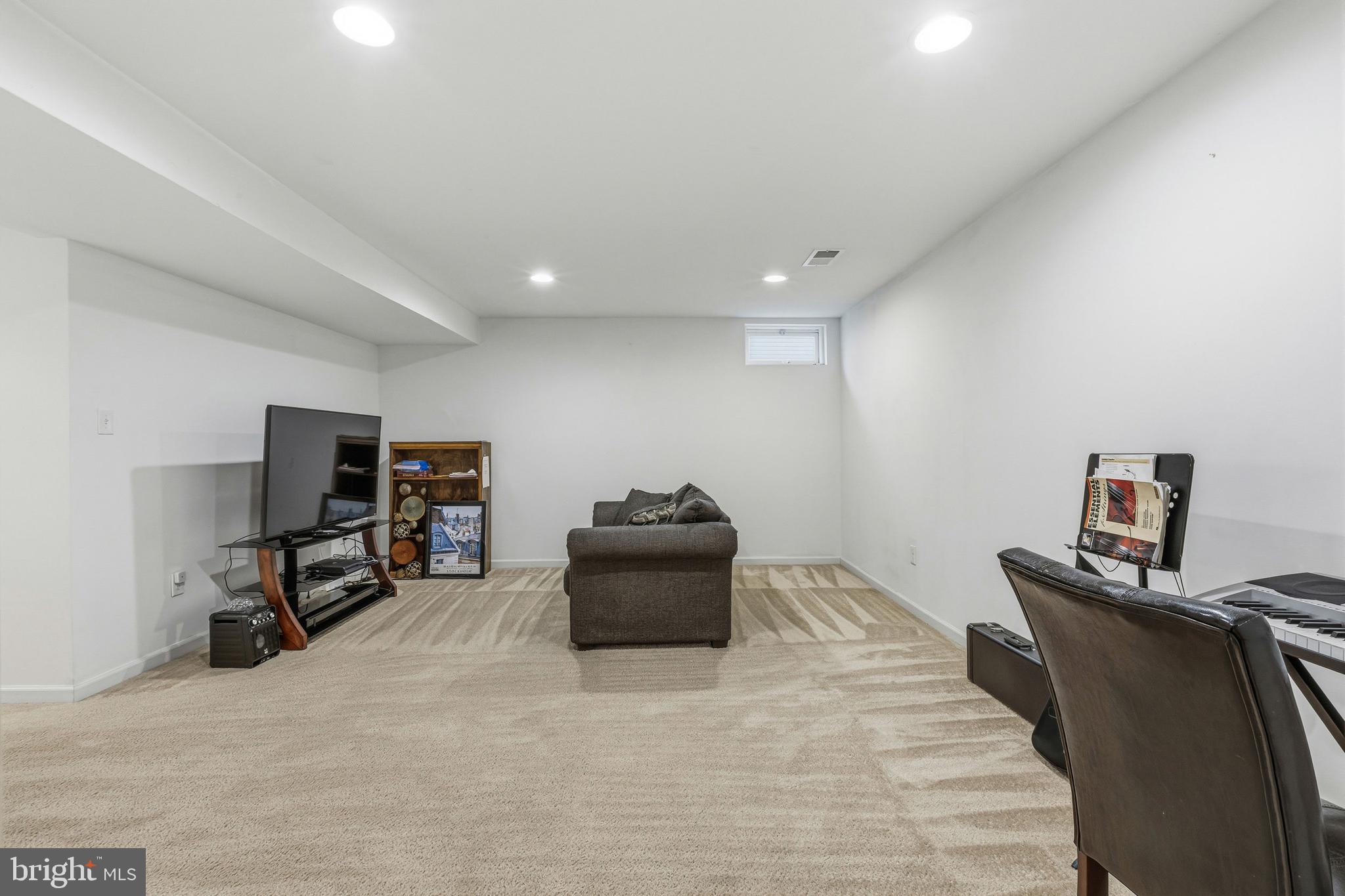 28 Snow Branch Road Clayton, DE 19938 - Photo 65 of 69 a living room with furniture and a flat screen tv