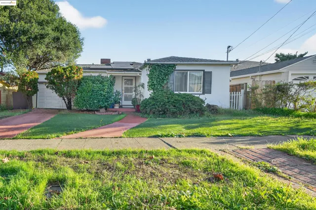 a view of a house with a big yard and potted plants