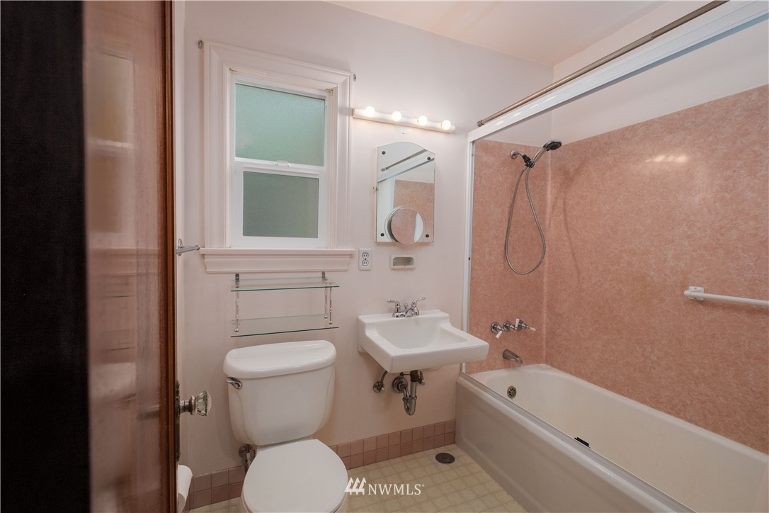 709 North 68th Street Seattle, WA 98103 - Photo 14 of 34 a bathroom with a toilet sink and shower
